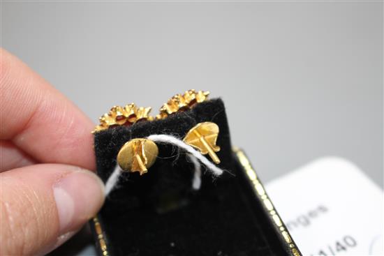 A pair of yellow metal and ruby cluster set flower head earrings, 13mm, gross weight 4.9 grams.